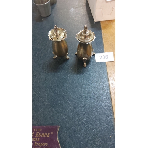 238 - Pair of sterling silver salt and pepper shakers, hallmarked, feature ornate twisted finials and foot... 