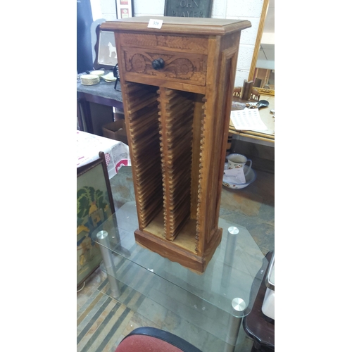 306 - Carved wooden CD rack with single decorative drawer, featuring intricate floral motifs. Made from wa... 