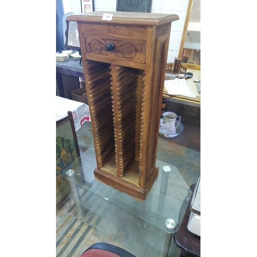 306 - Carved wooden CD rack with single decorative drawer, featuring intricate floral motifs. Made from wa... 