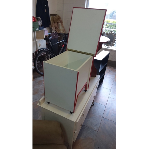 308 - Retro wooden storage box on wheels, featuring a hinged lid, painted in cream with red trim.