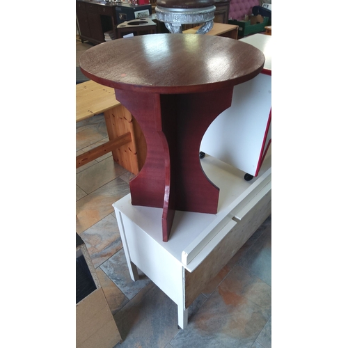 309 - Round wooden side table with a sculptural base, featuring a dark mahogany finish.