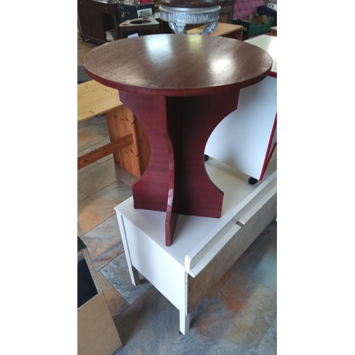 309 - Round wooden side table with a sculptural base, featuring a dark mahogany finish.