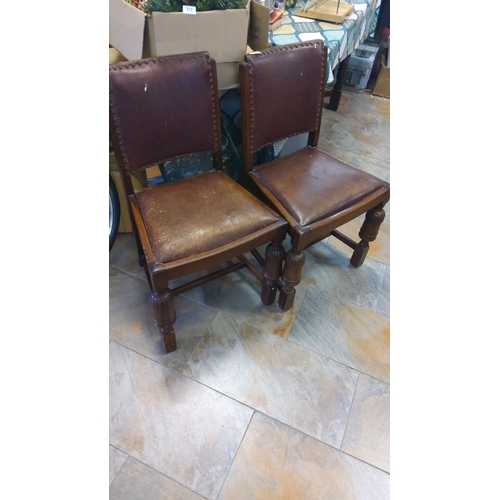 311 - Pair of vintage wooden chairs with brown leather upholstery and decorative stud detailing feature tu... 