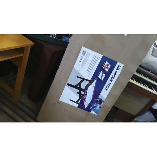 319 - Boxed Air Hockey Table with equipment, new in package. The play surface features an electronic score... 