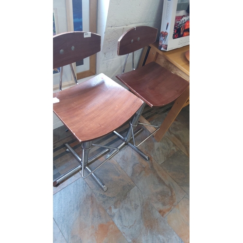 325 - Pair of mid-century modern stools with wooden seats and metal frames.