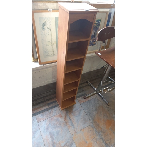 326 - Tall wooden storage tower with multiple shelves, in oak finish.