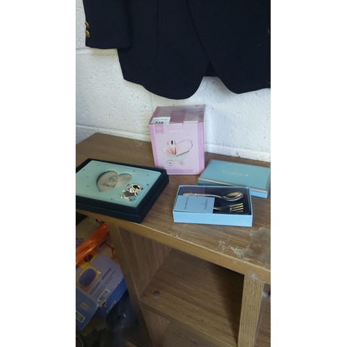 329 - Set of three new baby present items including a photo frame, a decorative pram money box, and a Newb... 