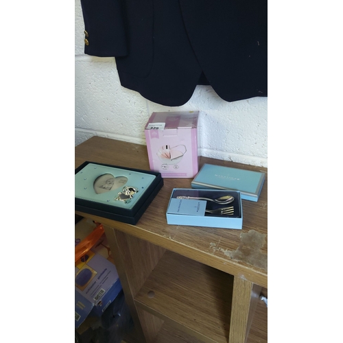 329 - Set of three new baby present items including a photo frame, a decorative pram money box, and a Newb... 