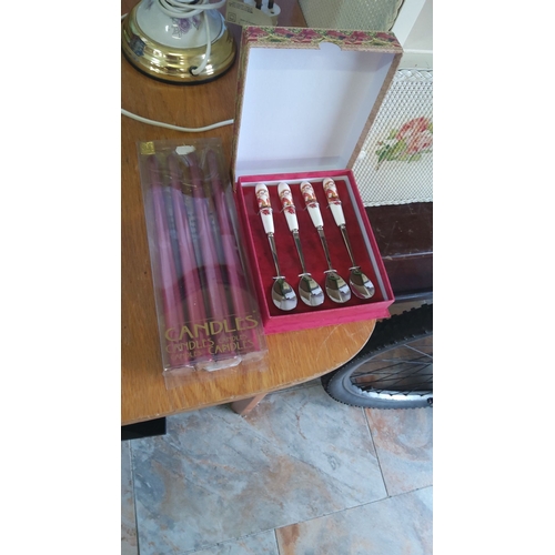 331 - Set of four Santa-themed spoons with ceramic handles, boxed. Accompanied by a pack of red candles, n... 