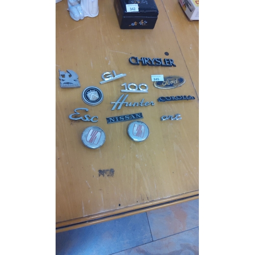 345 - Collection of vintage car badges and emblems, featuring brands like Chrysler, Ford, Nissan, Vauxhall... 