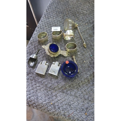 349 - Mixed metalware collection featuring silver napkin rings, ornate salt cellars with cobalt blue liner... 