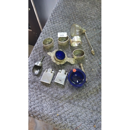 349 - Mixed metalware collection featuring silver napkin rings, ornate salt cellars with cobalt blue liner... 