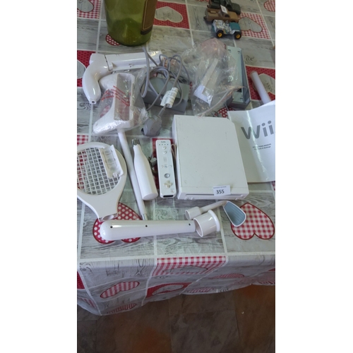 355 - Nintendo Wii console with remote, attachments, and operations manual.(no sensor included)
