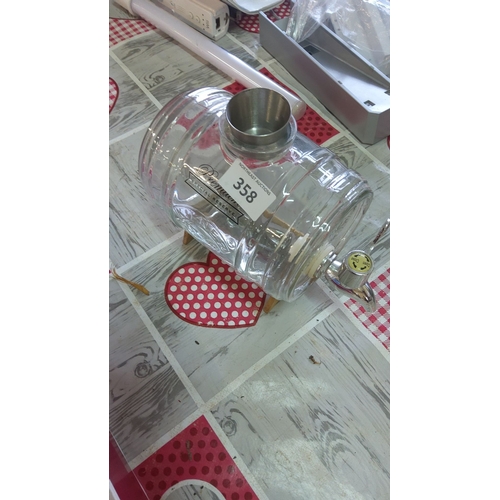 358 - Glass barrel decanter with wooden stand and shot measure,featuring a metal spout and 