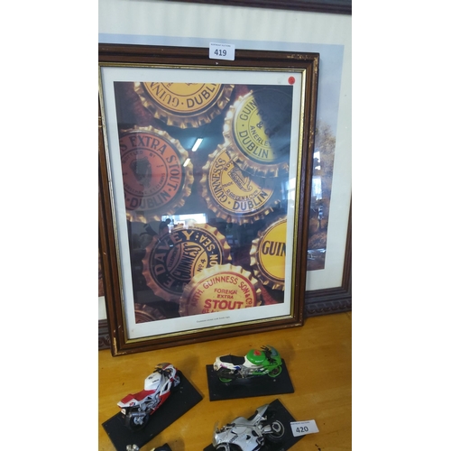 419 - Framed original print of Guinness bottle caps showcases vintage Dublin stout branding.