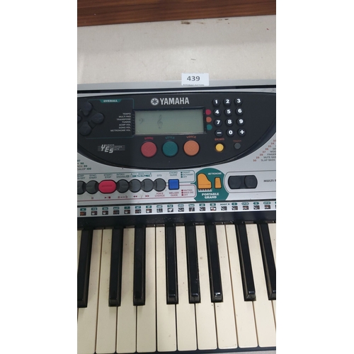 439 - Yamaha electronic keyboard with various function buttons and digital display. Includes built-in spea... 