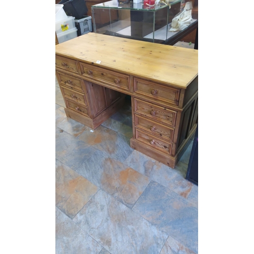 445 - Antique pine wood desk featuring multiple drawers with turned wooden knobs.