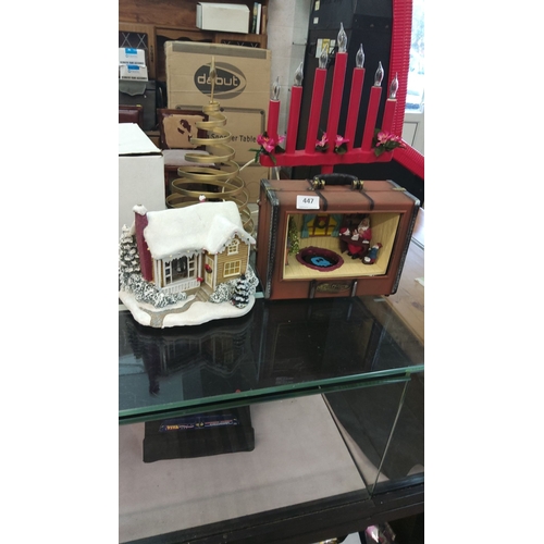 447 - Decorative Christmas lot includes a snow-covered cottage, a Santa display in a suitcase-shaped box, ... 
