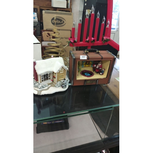 447 - Decorative Christmas lot includes a snow-covered cottage, a Santa display in a suitcase-shaped box, ... 
