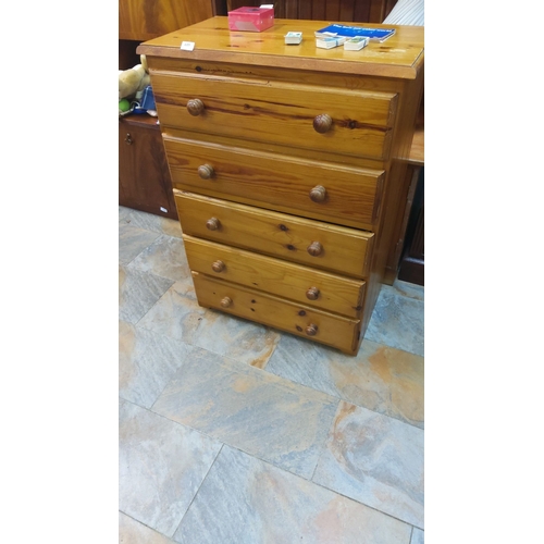 449 - Pine chest of five drawers with round wooden knobs, showcasing natural grain.