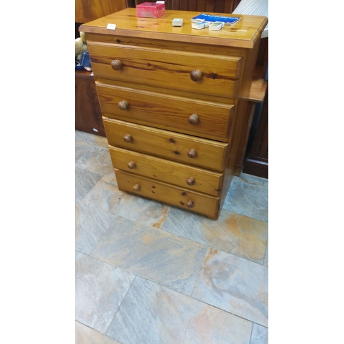 449 - Pine chest of five drawers with round wooden knobs, showcasing natural grain.