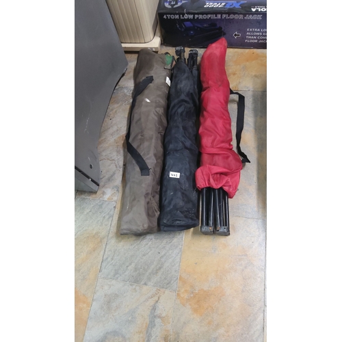 465 - Three portable camping chairs with carry bags in brown, black, and red. Each features foldable steel... 