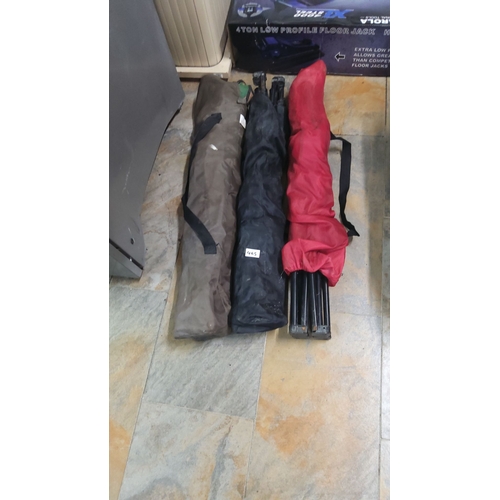 465 - Three portable camping chairs with carry bags in brown, black, and red. Each features foldable steel... 