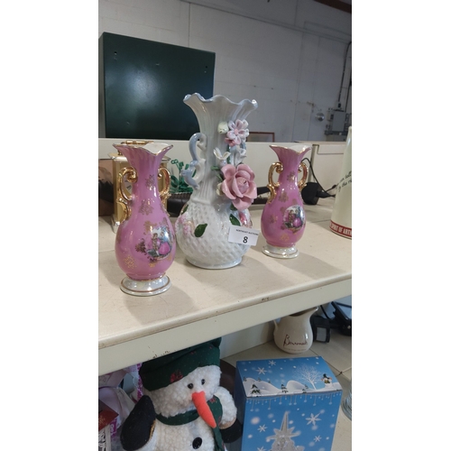 8 - Set of three decorative porcelain vases: two pink with gilt handles and courtship scenes, one white ... 