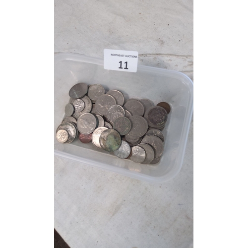 11 - Collection of assorted world coins in a plastic container. Various sizes and designs, primarily silv... 