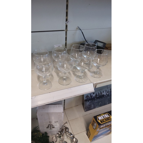 12 - Set of eight clear glass goblets, each featuring a classic rounded bowl and sturdy stem.