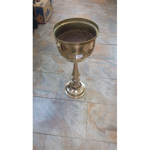 122 - Brass standing planter with decorative embossed design, featuring a tall pedestal base.