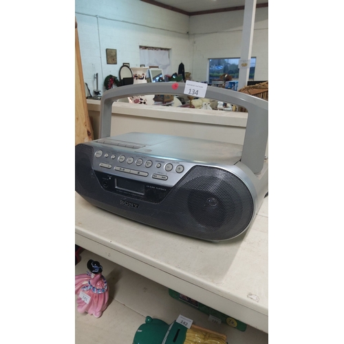 134 - Sony CD/cassette boombox with radio functionality, featuring a durable handle and integrated speaker... 