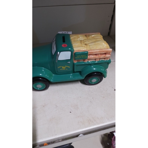 142 - Ceramic piggy bank modeled as a John Deere pick up truck with hay crates, featuring 