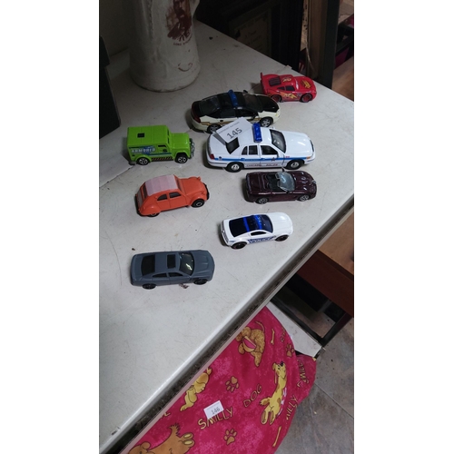 145 - Set of eight die-cast model cars includes police, armored vehicles, and classic designs. Includes a ... 