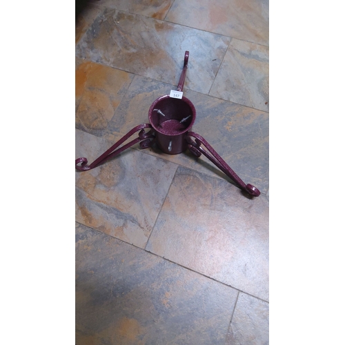 147 - Wrought iron Christmas tree stand with decorative scrollwork, finished in speckled burgundy.