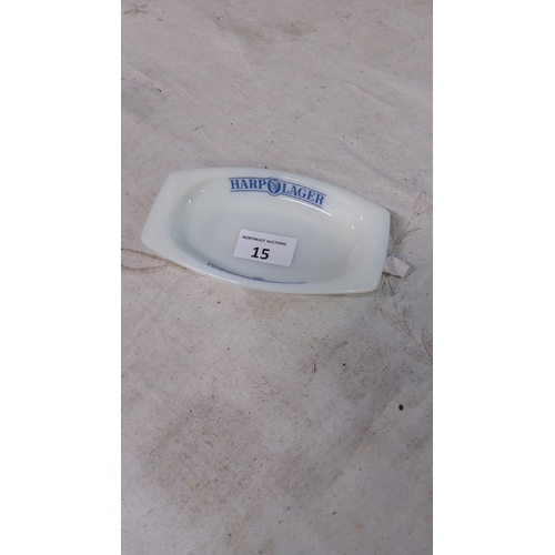 15 - Ceramic harp lager ashtray, oval shape, featuring blue logo.