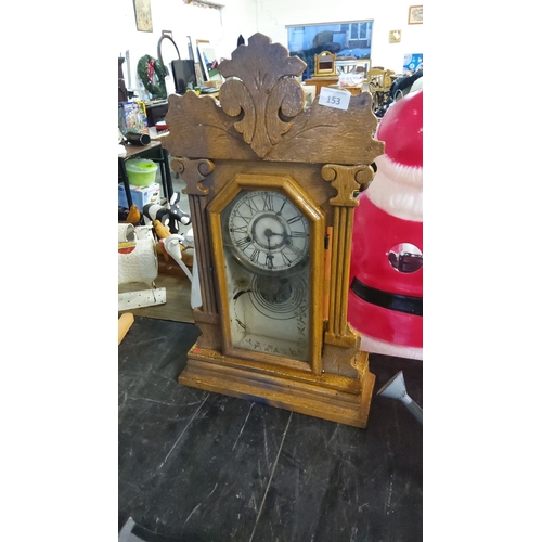 153 - Wooden gingerbread mantel clock features Roman numerals, detailed Victorian-style carvings, and a gl... 