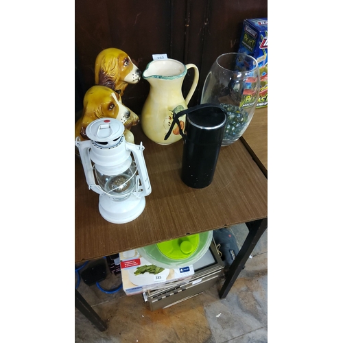 162 - Ceramic dog figurines, hand-painted pitcher, vintage white lantern, black thermos, and glass jar wit... 