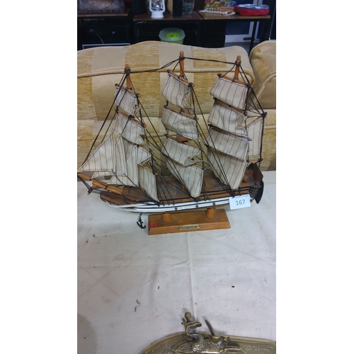 167 - Wooden model ship of the U.S.S. Constitution features detailed sails and rigging. It is displayed on... 