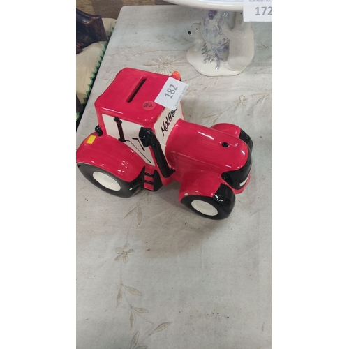 182 - Ceramic red tractor-shaped piggy bank featuring 