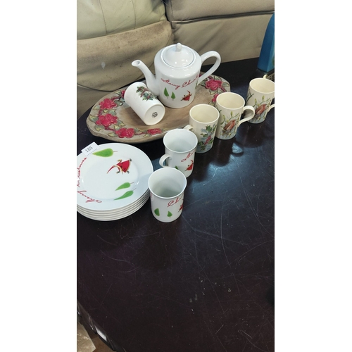 185 - Bone Christmas-themed tea set with teapot,6 mugs, and 6 plates with tray. Each adorned with festive ... 