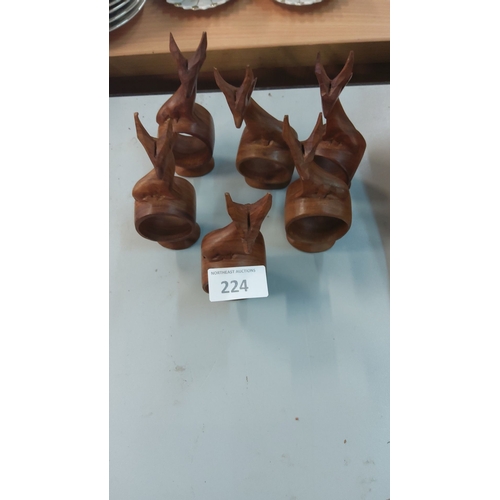 224 - Set of five wooden festive napkin rings, featuring abstract carved animal shapes. Natural wood grain... 