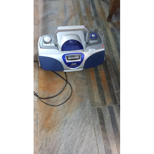 236 - JVC CD/cassette player with radio features a handle for easy transport and a blue and silver design.