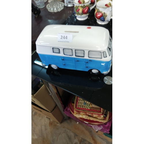 244 - Ceramic money box shaped like a vintage VW campervan, hand-painted in blue and white, featuring coin... 