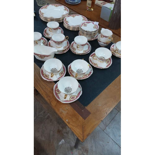 247 - Fine Bone China tea set, made in England, featuring gold accents and floral patterns. Includes cups,... 