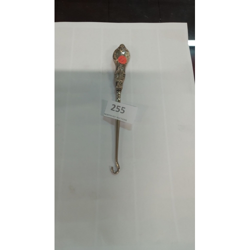 255 - Sterling silver ornate handled button hook, featuring intricate floral motifs.