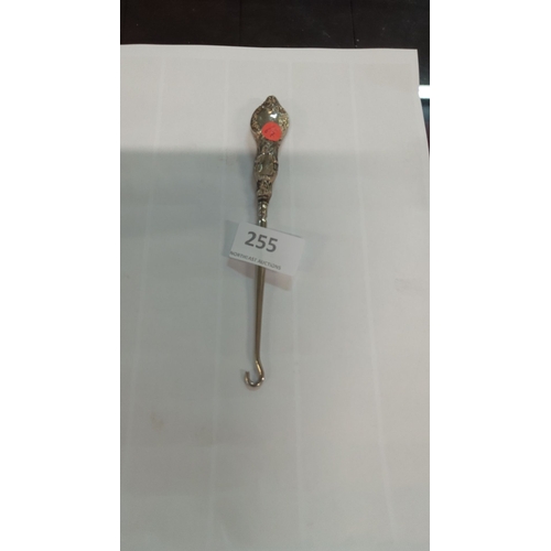 255 - Sterling silver ornate handled button hook, featuring intricate floral motifs.