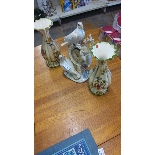 278 - Hand-painted ceramic clock with bird motif, accompanied by two matching capodimonte floral vases, ad... 