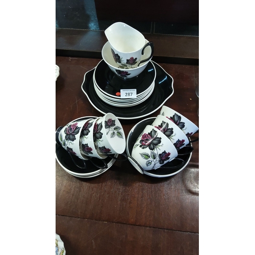 287 - Royal Albert 21 pce bone china tea set with floral motif, featuring black and red roses