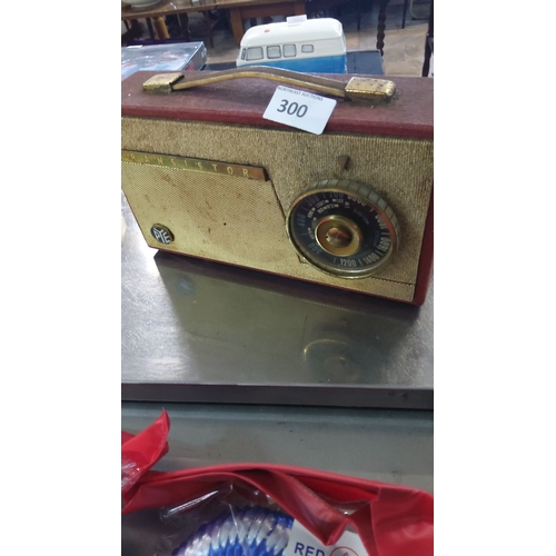 300 - Vintage PYE transistor radio with fabric covering and brass handle, features a classic circular tuni... 